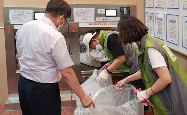 성사1동 관계자들이 세탁물을 수거하고 있다.