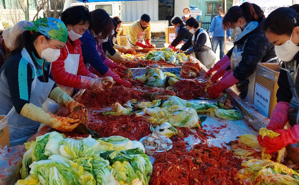 사랑의 김장나눔에 참여한 주민들이 장갑을 끼고 맛있는 김장을 담그고 있다.