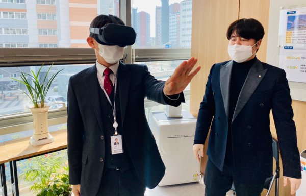 김진우 센터장과 이유고 대표이사가 VR오큘러스 퀘스트로 시각장애체험을 시연하고 있다.