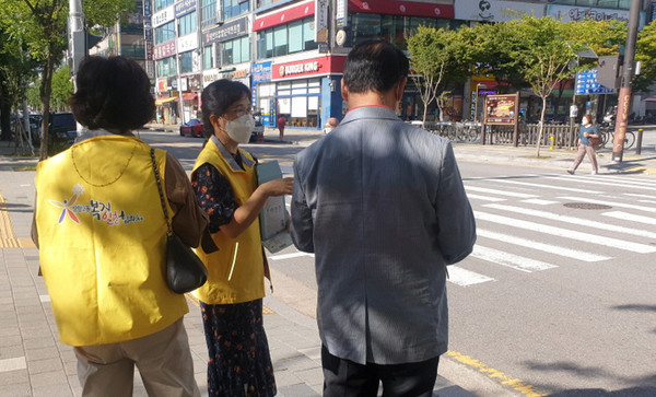 장항2동 지역사회보장협의체 위원들과 직원들 주민들에게 어려운 이웃에 대한 관심을 부탁하며, 안내문과 홍보물품을 전달하고 있다. 