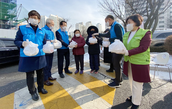 현장에서 지역민들에게 음식꾸러미를 전달하는 봉사자들.