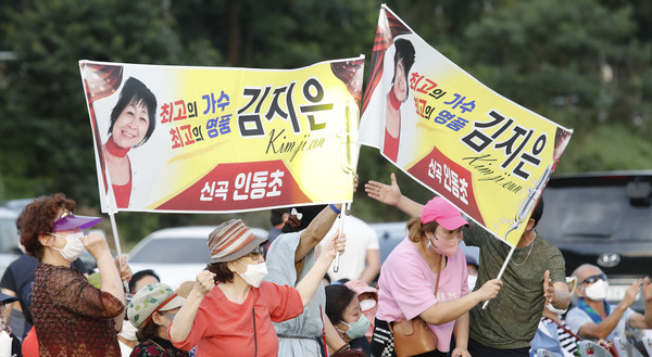 플래카드로 응원을 하고 있는 가수 김지은 씨의 지인들.