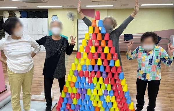  어르신들이 컵을 놓게 쌓은 모습을 기념으로 촬영했다.