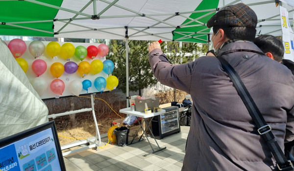 복 터트리기(풍선 다트 던지기)를 하는 주민들.