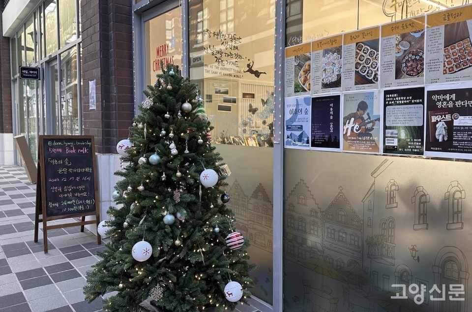 외부에서 계단을 통해 올라가면 보이는 책방 입구. 투명한 유리창에는 다양한 행사포스터가 붙어있다.