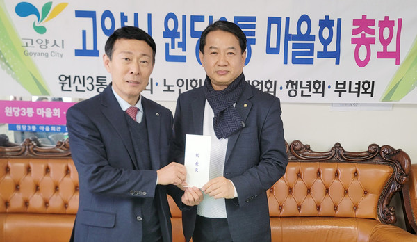 이창림 원당농협 조합장(왼쪽)이 원당3통 마을회에 후원금을 전달하고 있다.