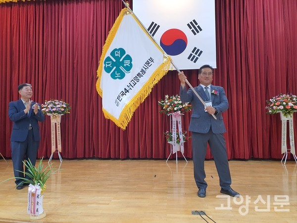 이준석 초대회장이 김종필 경기도본부회장으로부터 본부기를 받고 힘차게 흔들고 있다