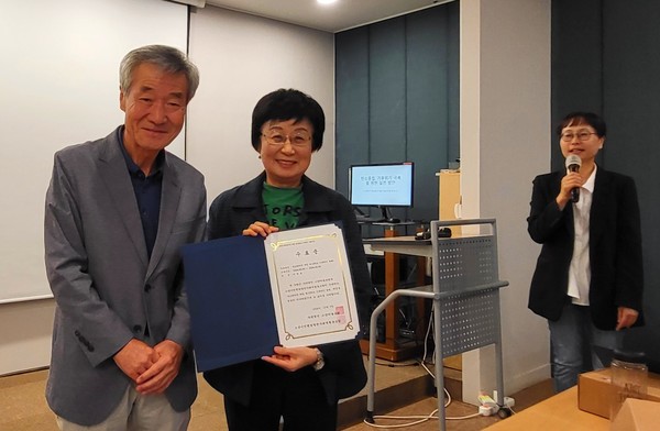 물방울팀의 이한용(오른쪽)씨가 사례발표를 하고 상을 받았다. 왼쪽은 윤주한 고양마을포럼 이사장.