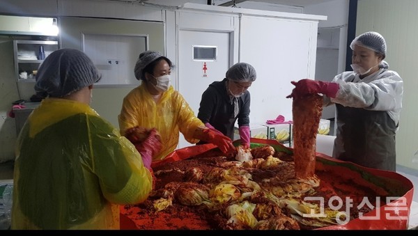 봉사자들이 김치를 정성스럽게 버무리고 있다.