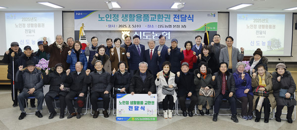 신도농협 노인정 생활용품 전달식에 함께한 참석자들이 파이팅을 하고 있다.