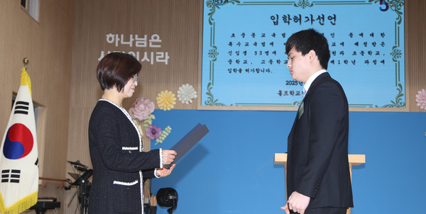 김정민 교장(왼쪽)이 권정민 학생대표에게  입학허가선언을 하고 있다. 