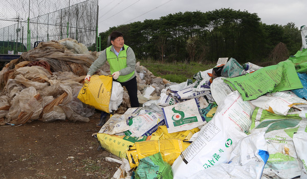 홍성규 조합장이 재활용 가능한 농자재를 분리하고 있다.