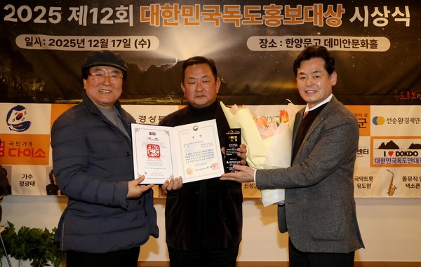 '2025 제12회 대한민국독도홍보대상'에서 영예의 문화체육관광부장관상을 수상한 김종학 케이원에코텍(주) 대표이사(가운데)가 가수 정광태(왼쪽), 길종성 독도사랑회 회장(오른쪽)과 함께 상장과 트로피를 들어 보이며 기념 촬영을 하고 있다.