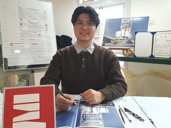 졸업작품전 자료들을 살펴보고 있다.