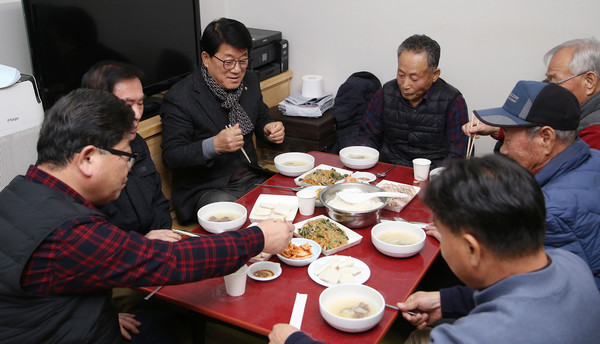  마을 대동회에서 지역민들과 떡과 잡채를 놓고 이야기를 나누고 있다.