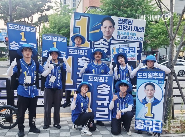 '검증된 고양시 재선'이라는 슬로건 아래 청년 선거운동원들과 함께 워킹보드를 착용하고 파이팅을 외치는 모습.