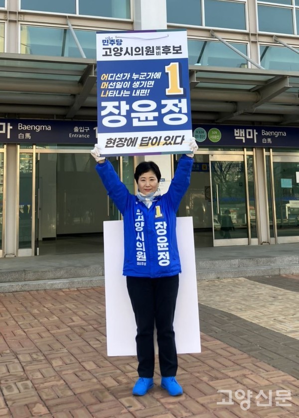 백마역 앞에서 '현장에 답이 있다'는 피켓을 들고 출근길 시민들에게 인사를 건네는 장윤정 당선인.
